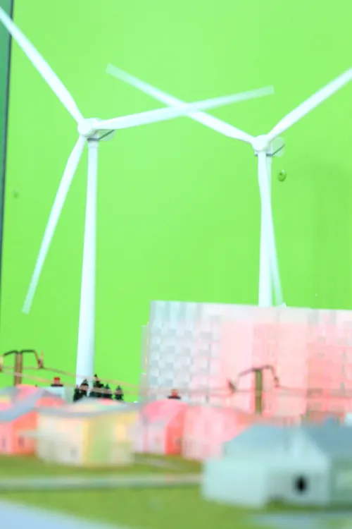 Person zeigt auf einen Touchscreen an einem technischen Exponat im Eingangsbereich.