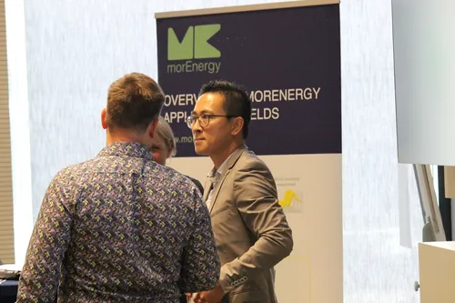 Referentin steht neben einem Roll-up-Banner und bereitet einen Vortrag vor.