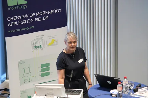 Gespräch zwischen Konferenzteilnehmern vor einem Informationsbanner.